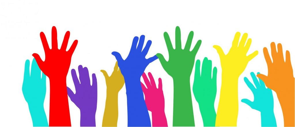 Colorful raised hands on white background